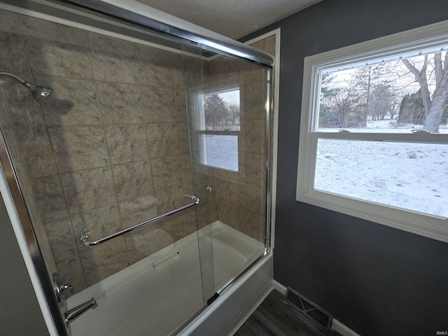 2914 Marian Ave, Lafayette, IN 47905 - full bath with combined bath / shower with glass door, healthy amount of natural light, wood finished floors, and baseboards