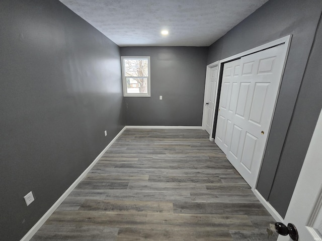 2914 Marian Ave, Lafayette, IN 47905 - unfurnished bedroom featuring baseboards, wood finished floors, a textured ceiling, and a closet
