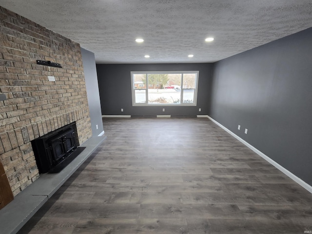 2914 Marian Ave, Lafayette, IN 47905 - unfurnished living room featuring baseboards, dark wood finished floors, recessed lighting, and a textured ceiling