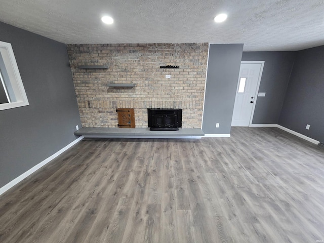 2914 Marian Ave, Lafayette, IN 47905 - unfurnished living room featuring a textured ceiling, baseboards, wood finished floors, and recessed lighting