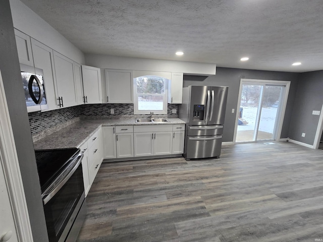 2914 Marian Ave, Lafayette, IN 47905 - kitchen with stainless steel appliances, a sink, tasteful backsplash, white cabinetry, and a textured ceiling