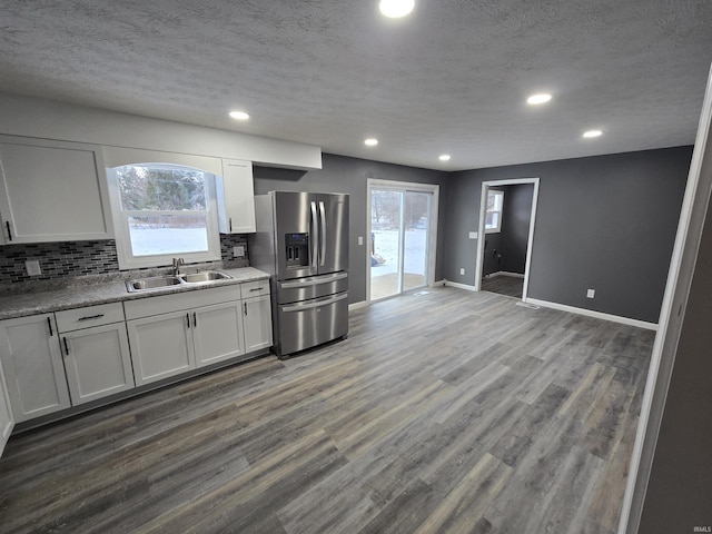 2914 Marian Ave, Lafayette, IN 47905 - kitchen featuring a sink, stainless steel fridge with ice dispenser, decorative backsplash, healthy amount of natural light, and a textured ceiling