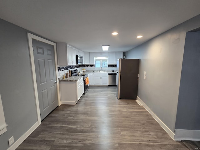 900 S 28th St, Lafayette, IN 47904 - kitchen featuring stainless steel appliances, a sink, dark wood finished floors, recessed lighting, and white cabinetry