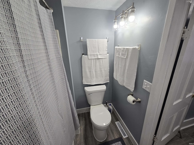900 S 28th St, Lafayette, IN 47904 - full bathroom featuring toilet, wood finished floors, baseboards, and curtained shower