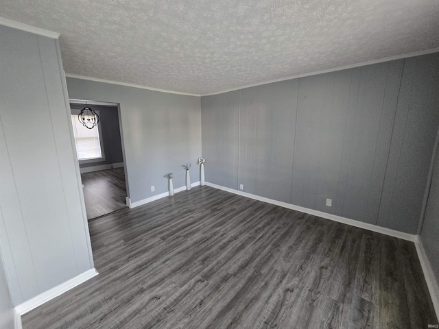 900 S 28th St, Lafayette, IN 47904 - empty room featuring dark wood-style flooring, a chandelier, a textured ceiling, ornamental molding, and baseboards