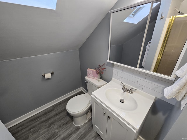 900 S 28th St, Lafayette, IN 47904 - bathroom with a skylight, wood finished floors, toilet, tasteful backsplash, and vaulted ceiling