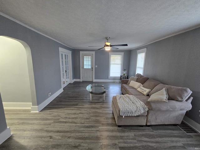 900 S 28th St, Lafayette, IN 47904 - living room with a textured ceiling, ornamental molding, arched walkways, baseboards, and dark wood-style floors