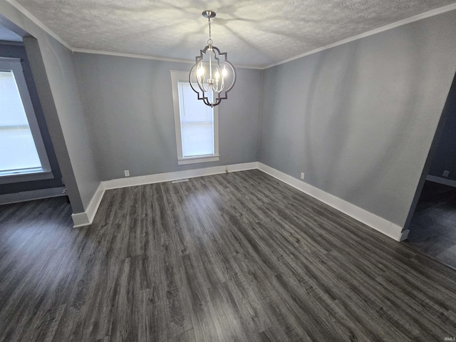 900 S 28th St, Lafayette, IN 47904 - unfurnished dining area featuring a textured ceiling, healthy amount of natural light, a chandelier, dark wood-style floors, and baseboards