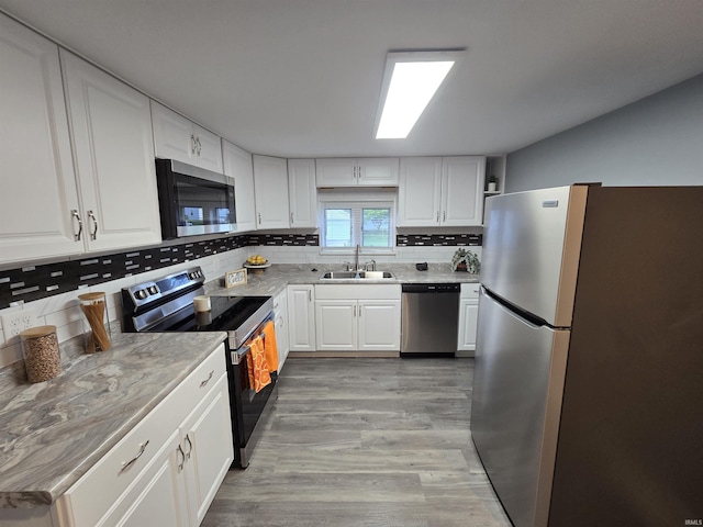 900 S 28th St, Lafayette, IN 47904 - kitchen featuring stainless steel appliances, a sink, backsplash, and white cabinets