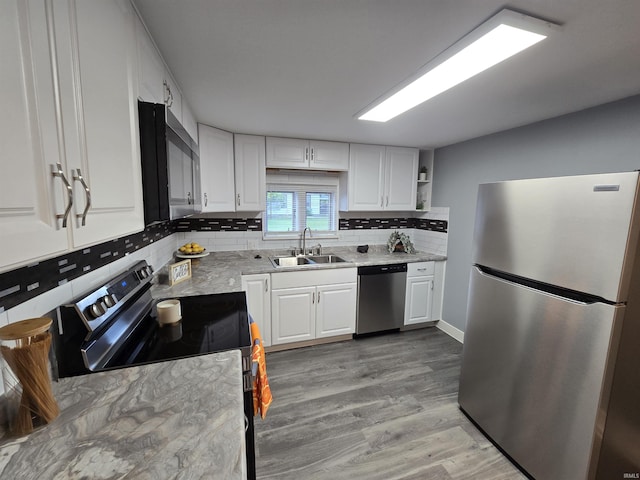 900 S 28th St, Lafayette, IN 47904 - kitchen featuring stainless steel appliances, a sink, white cabinetry, and decorative backsplash