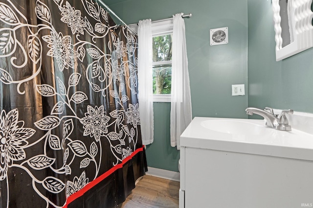3422 S Calhoun St, Fort Wayne, IN 46807 - full bathroom with vanity, wood finished floors, shower / bath combination with curtain, and baseboards