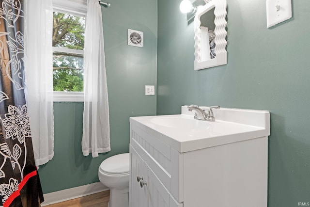 3422 S Calhoun St, Fort Wayne, IN 46807 - bathroom featuring toilet, plenty of natural light, vanity, and wood finished floors