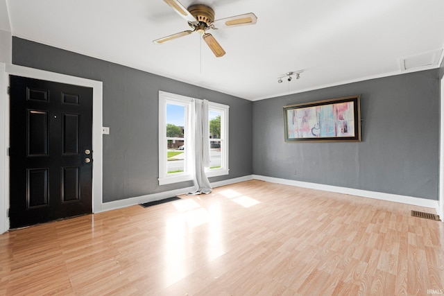 3422 S Calhoun St, Fort Wayne, IN 46807 - empty room with baseboards, wood finished floors, a ceiling fan, track lighting, and crown molding