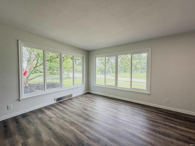 2425 Ojibway Trl, Fort Wayne, IN 46809 - empty room featuring dark wood-style floors, baseboards, and a textured ceiling
