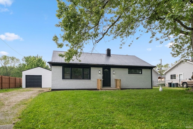 590 Brandford Ct, New Haven, IN 46774 - view of front of home with driveway, an outbuilding, brick siding, metal roof, and a chimney