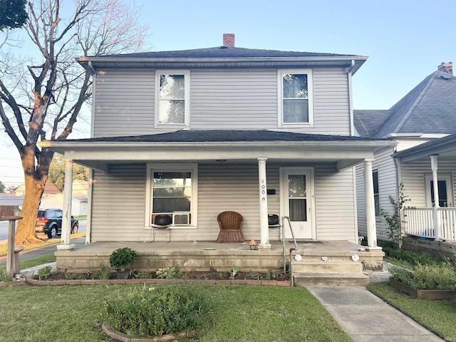 400 Burlington Ave, Logansport, IN 46947 - american foursquare style home featuring a porch, a chimney, and a front lawn