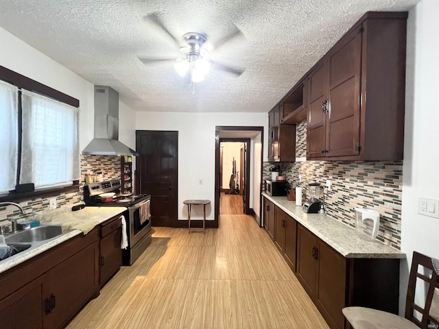 400 Burlington Ave, Logansport, IN 46947 - kitchen featuring wall chimney range hood, appliances with stainless steel finishes, a sink, dark brown cabinetry, and a textured ceiling