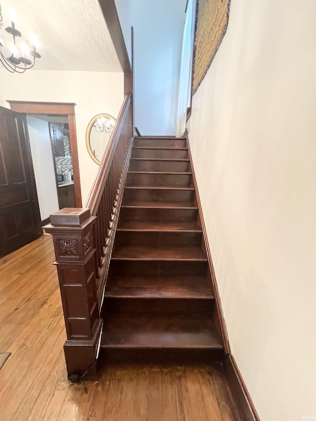 400 Burlington Ave, Logansport, IN 46947 - stairs featuring hardwood / wood-style floors and baseboards