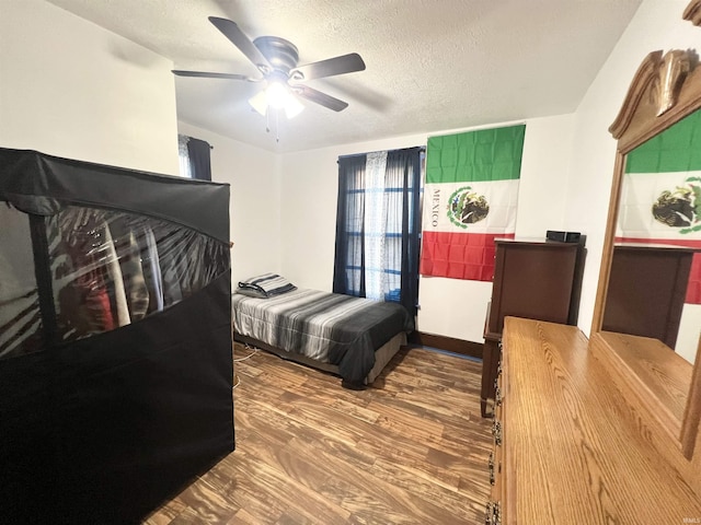 400 Burlington Ave, Logansport, IN 46947 - bedroom with a textured ceiling, wood finished floors, and ceiling fan