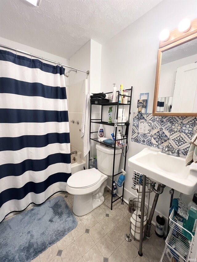 400 Burlington Ave, Logansport, IN 46947 - full bathroom featuring toilet, shower / bath combination with curtain, tile patterned flooring, a textured ceiling, and backsplash