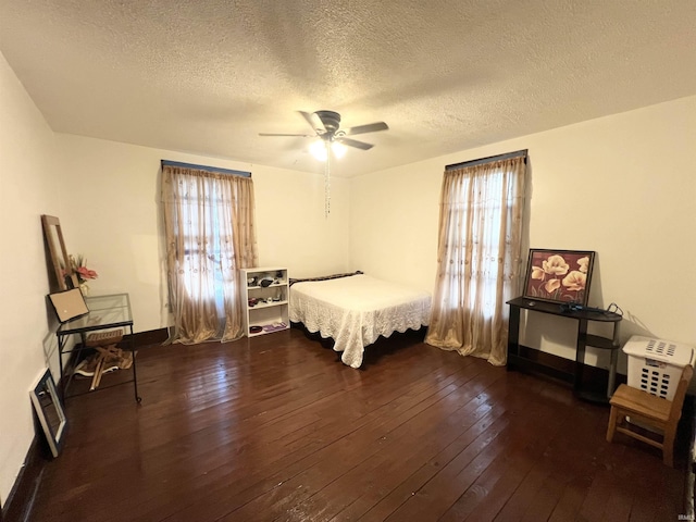 400 Burlington Ave, Logansport, IN 46947 - bedroom featuring multiple windows, wood-type flooring, a textured ceiling, ceiling fan, and baseboards