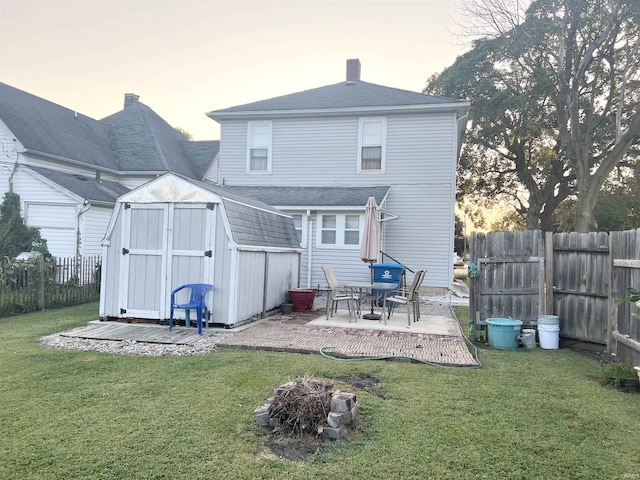 400 Burlington Ave, Logansport, IN 46947 - back of house at dusk featuring a patio and a chimney