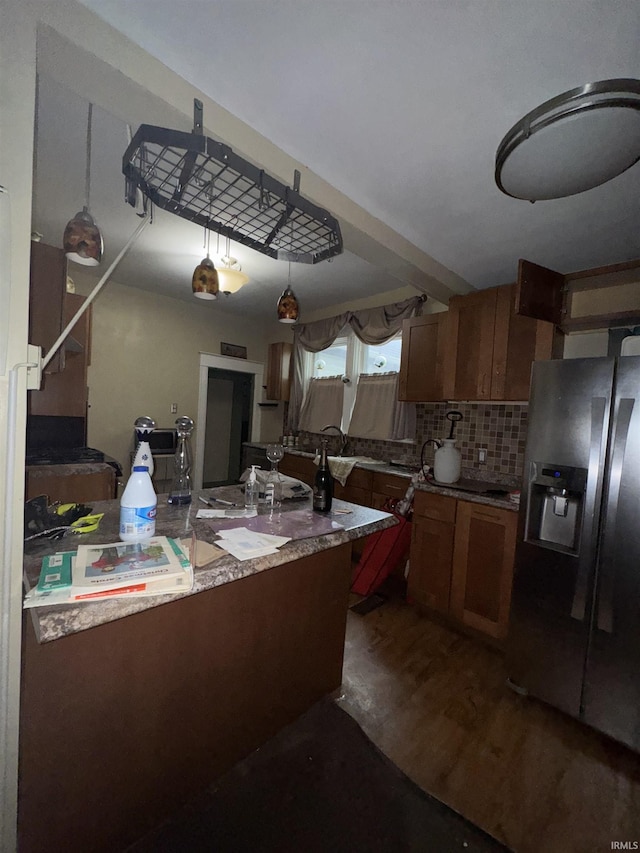 457 E Leith St, Fort Wayne, IN 46806 - kitchen with stainless steel refrigerator with ice dispenser, tasteful backsplash, brown cabinetry, and dark wood finished floors