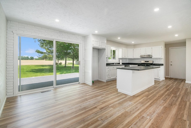 4624 3b Rd, Bremen, IN 46506 - kitchen featuring stainless steel range, white cabinetry, light wood-style floors, dark countertops, and recessed lighting