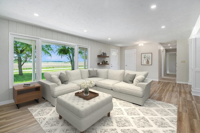 4624 3b Rd, Bremen, IN 46506 - living room with recessed lighting, baseboards, light wood-style floors, and a textured ceiling