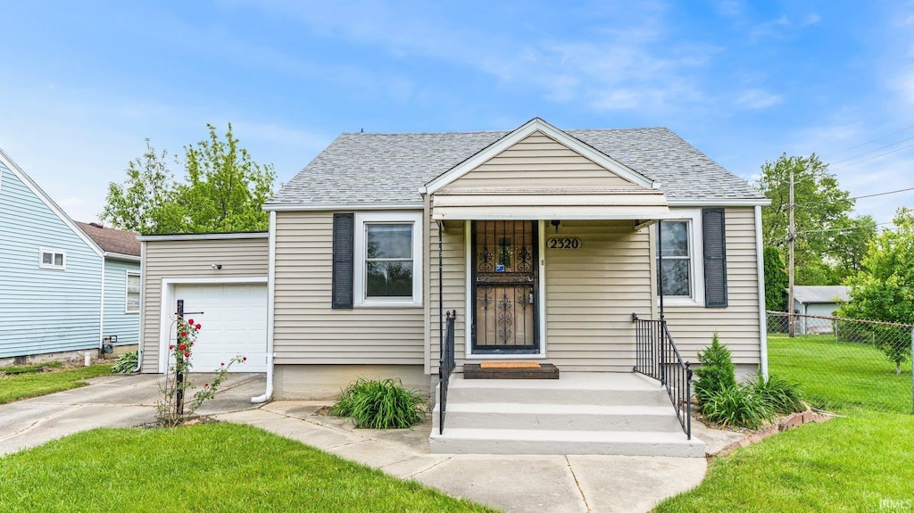 2320 Whitmore Ave, Fort Wayne, IN 46802 - bungalow featuring concrete driveway, a shingled roof, and a garage