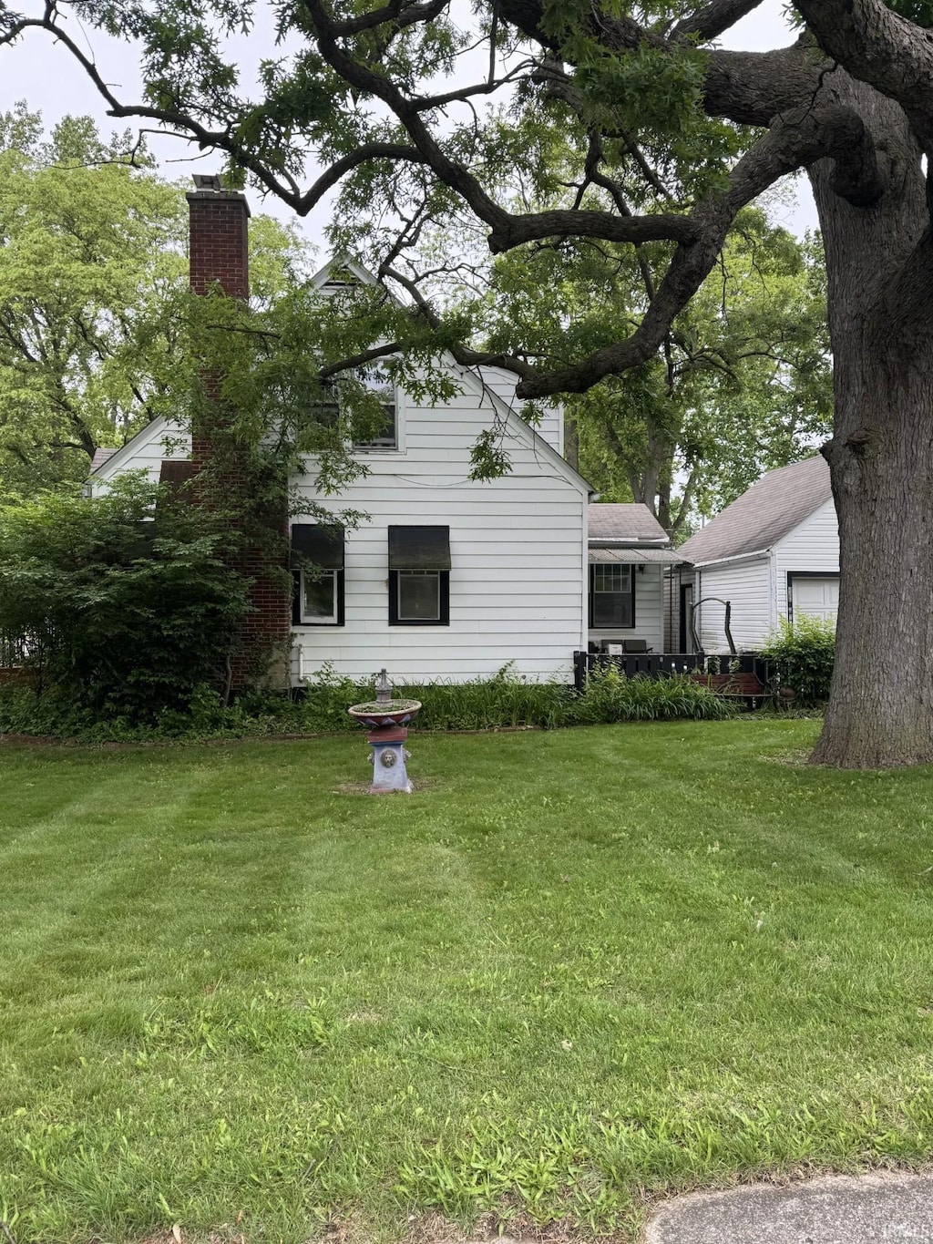 3306 Eastbrook Dr, Fort Wayne, IN 46805 - rear view of property featuring a chimney and a yard