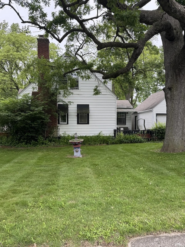 3306 Eastbrook Dr, Fort Wayne, IN 46805 - rear view of property featuring a chimney and a yard