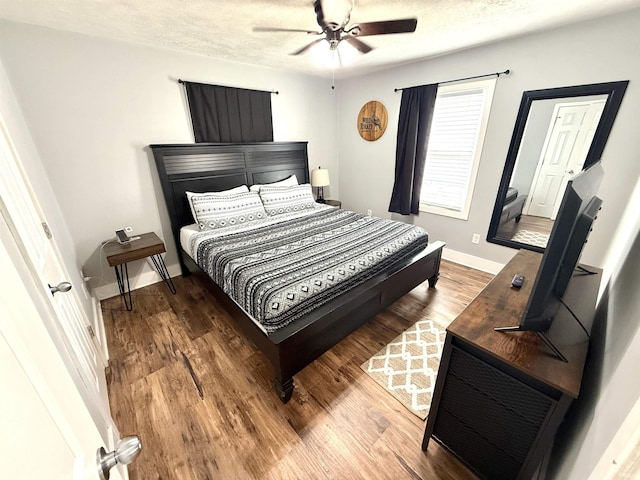 3833 Clover Dr, Newburgh, IN 47630 - bedroom with wood finished floors, a textured ceiling, baseboards, and ceiling fan