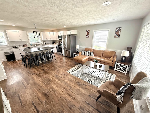 3833 Clover Dr, Newburgh, IN 47630 - living area with a textured ceiling, recessed lighting, and dark wood-style flooring