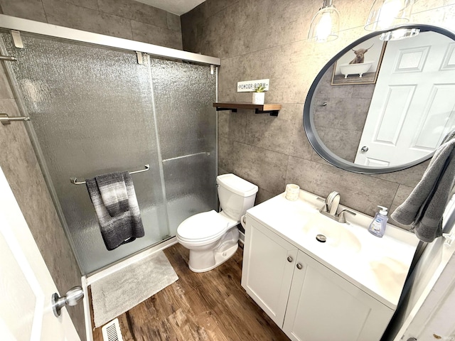 3833 Clover Dr, Newburgh, IN 47630 - bathroom with wood finished floors, vanity, a shower stall, toilet, and tile walls