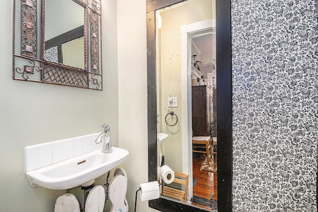 411 S 6th St, Goshen, IN 46526 - bathroom featuring a sink and wood finished floors