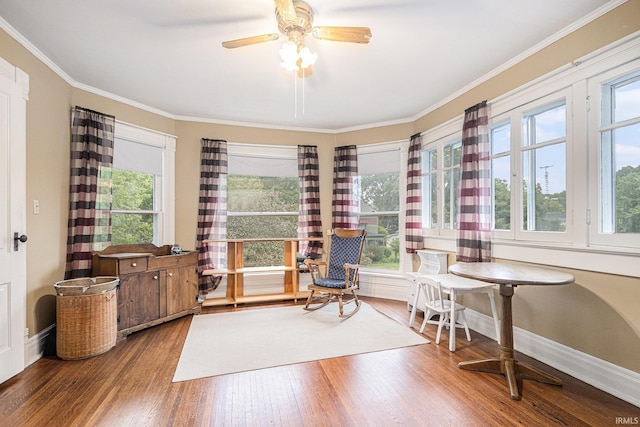 411 S 6th St, Goshen, IN 46526 - living area with wood finished floors, healthy amount of natural light, ceiling fan, ornamental molding, and baseboards