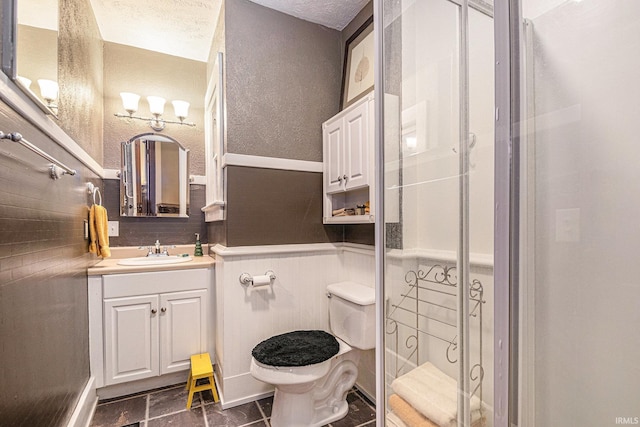 411 S 6th St, Goshen, IN 46526 - full bathroom featuring toilet, vanity, a shower stall, and a textured ceiling