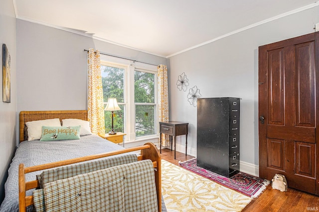 411 S 6th St, Goshen, IN 46526 - bedroom with wood finished floors, crown molding, and baseboards