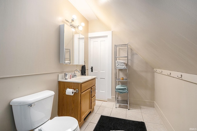411 S 6th St, Goshen, IN 46526 - bathroom with vanity, toilet, tile patterned flooring, and vaulted ceiling