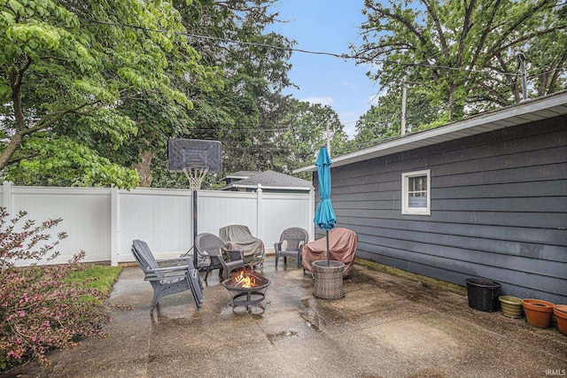 411 S 6th St, Goshen, IN 46526 - fenced backyard with a fire pit and a patio area