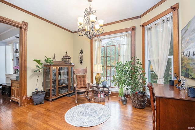 411 S 6th St, Goshen, IN 46526 - sitting room with wood-type flooring, a chandelier, ornamental molding, and baseboards