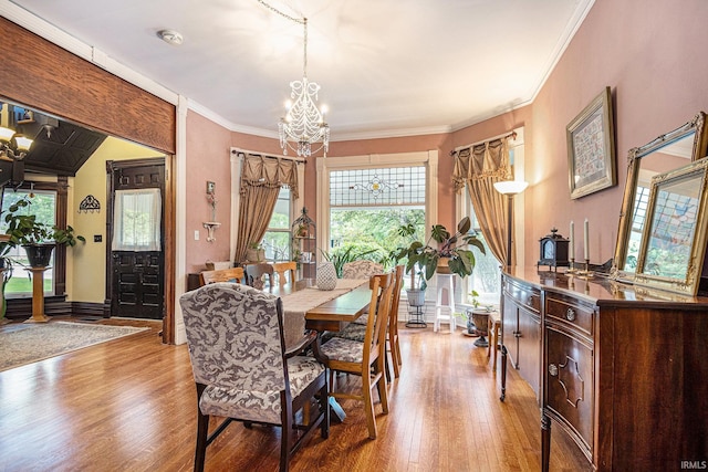 411 S 6th St, Goshen, IN 46526 - dining space featuring a chandelier, light wood finished floors, ornamental molding, and baseboards