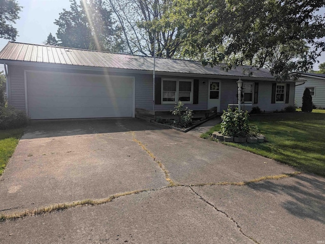 417 S Linn Grove Ave, Berne, IN 46711 - ranch-style home featuring a garage, driveway, a front lawn, and metal roof