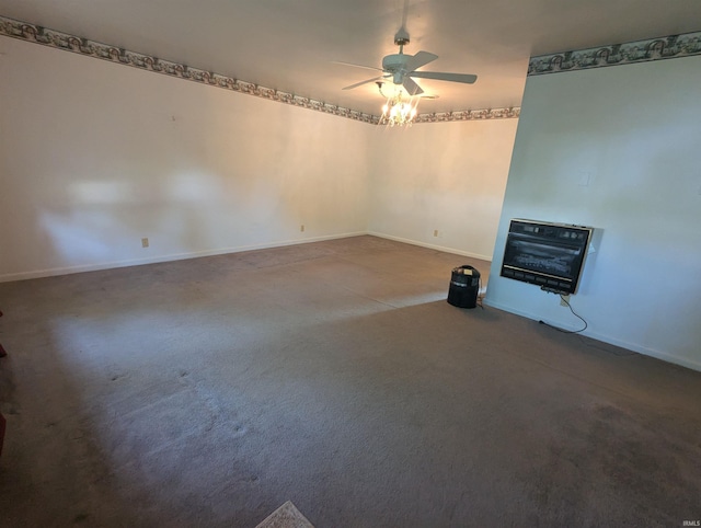 417 S Linn Grove Ave, Berne, IN 46711 - carpeted spare room with ceiling fan, baseboards, a glass covered fireplace, and heating unit