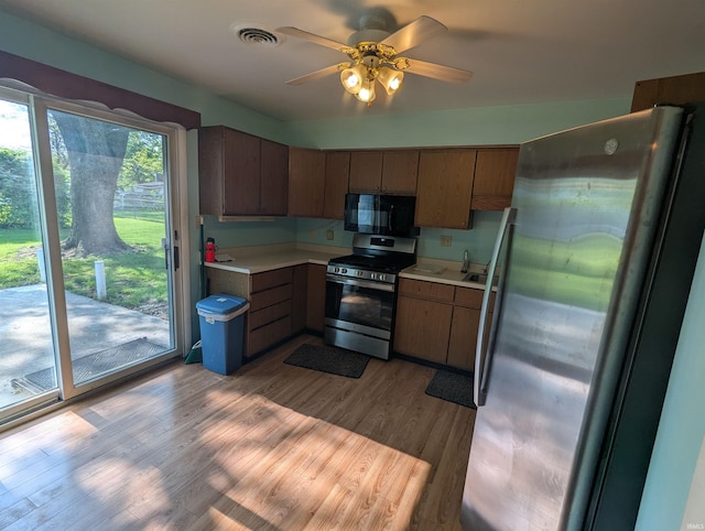 417 S Linn Grove Ave, Berne, IN 46711 - kitchen with stainless steel appliances, light countertops, ceiling fan, and wood finished floors