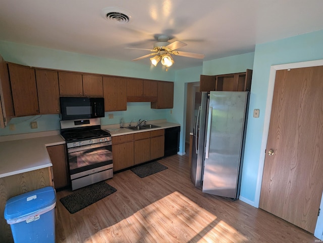 417 S Linn Grove Ave, Berne, IN 46711 - kitchen featuring black appliances, a sink, light countertops, a ceiling fan, and light wood-type flooring