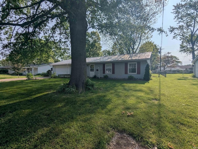417 S Linn Grove Ave, Berne, IN 46711 - ranch-style house with a front lawn, a garage, and metal roof