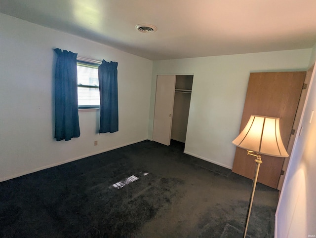 417 S Linn Grove Ave, Berne, IN 46711 - unfurnished bedroom featuring a closet, dark colored carpet, and baseboards