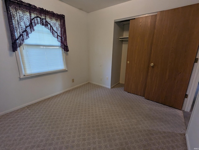 417 S Linn Grove Ave, Berne, IN 46711 - unfurnished bedroom featuring multiple windows, carpet, a closet, and baseboards